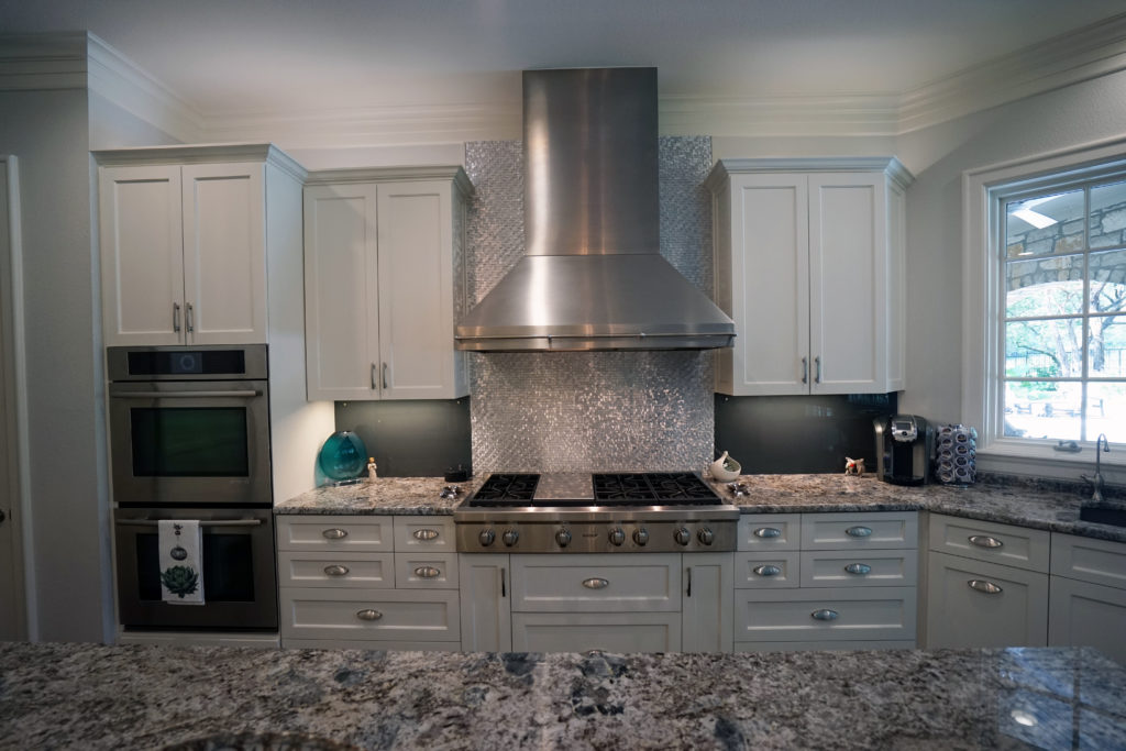 kitchen remodel with hood and tile to ceiling